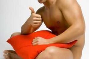 A man prepares for jelq exercise - penis enlargement