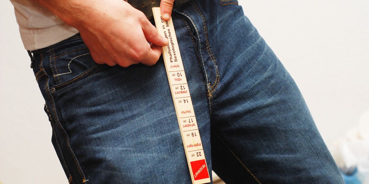 A man measures his member's length